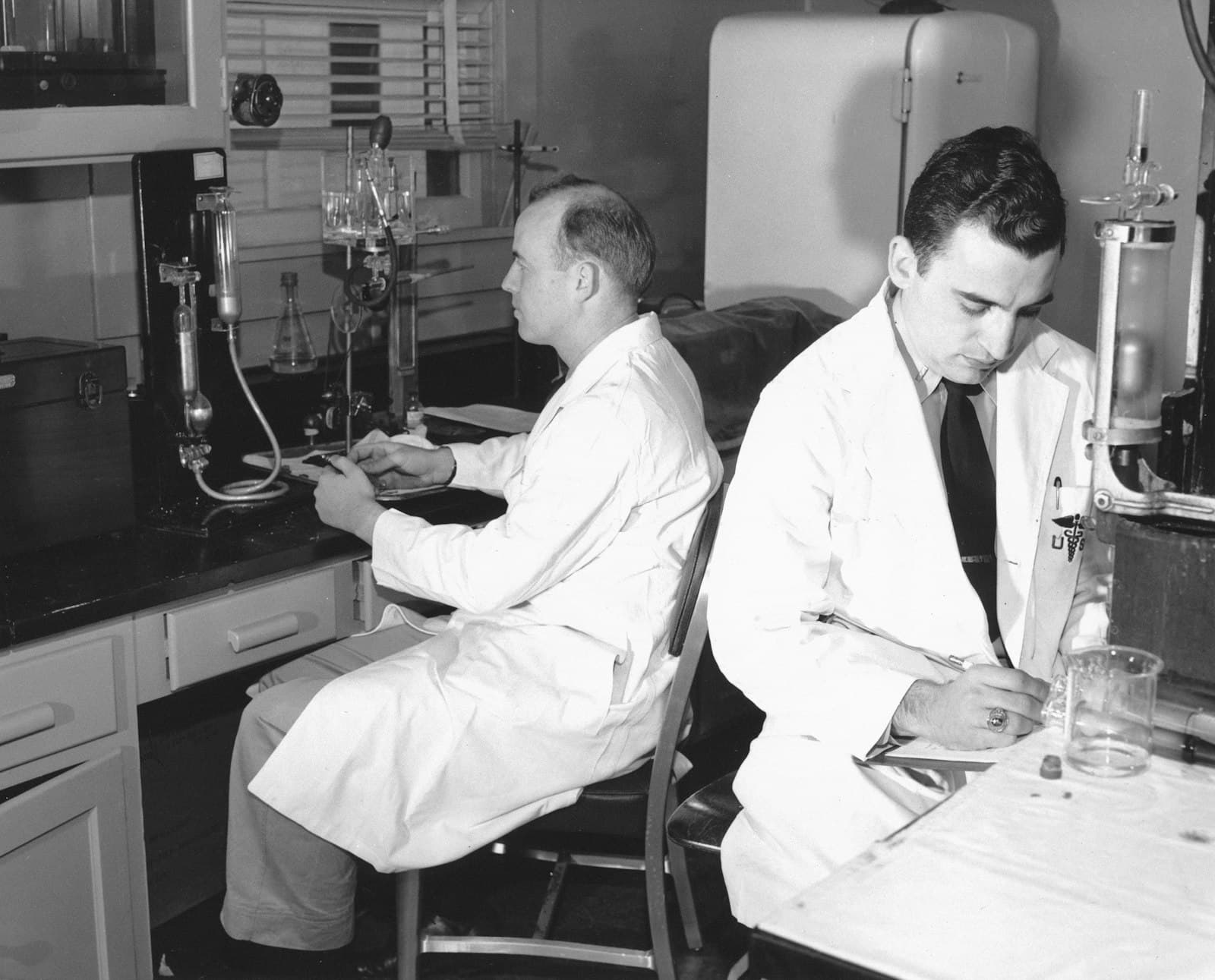 Two researchers in lab coats working in a laboratory